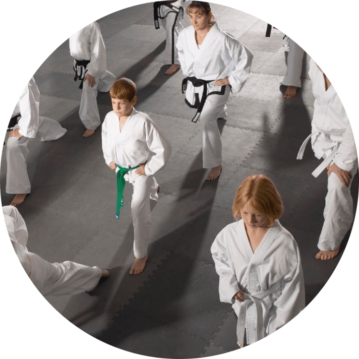 A group of people in white uniforms practicing martial arts.